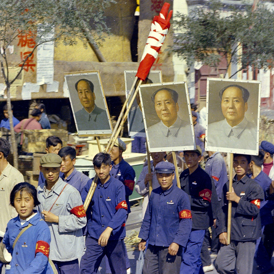 Red Guards carrying pictures of Chairman Mao march on Hangchow Street in Peking, Sept. 1966
