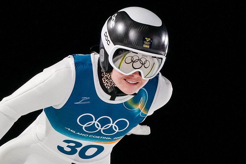 The Olympic rings are reflected on the goggles of Frida Westman during the ski jumping women's normal hill individual, at the 2026 Winter Olympics