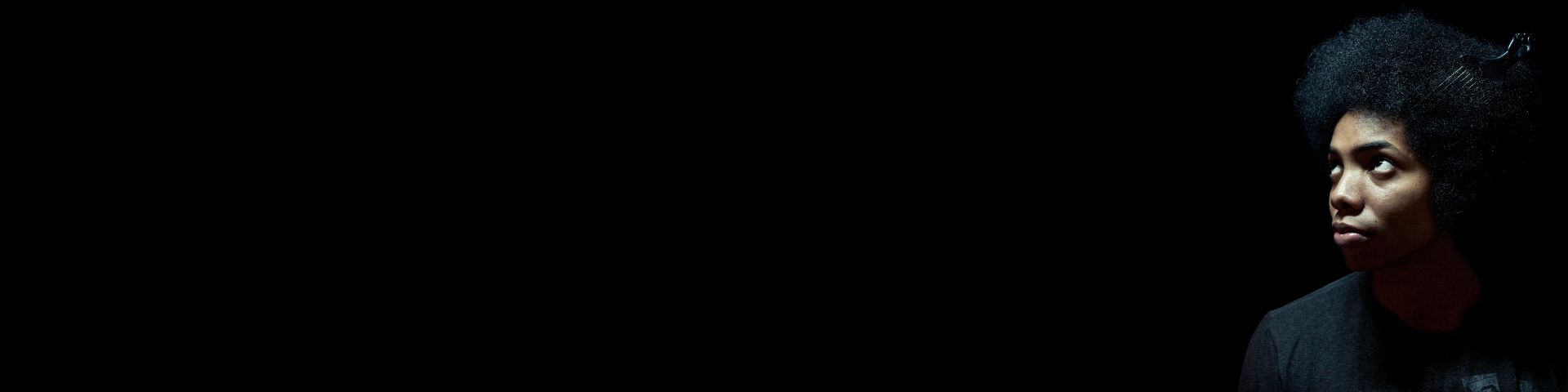 African American man wearing comb in afro hairstyle.